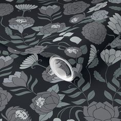 a black and grey floral wallpaper with white flowers on it's side,