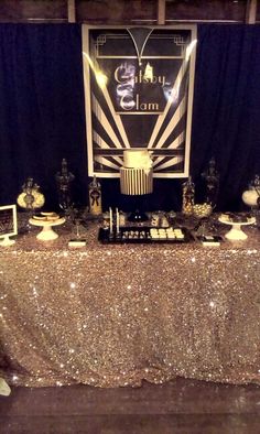 the table is set up with gold sequins and silver plates on it, along with other decorations