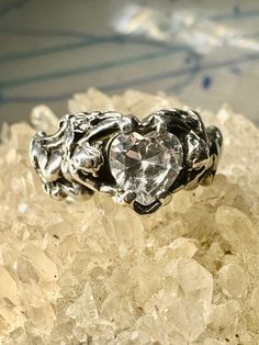 "Cupid ring size 8.25 holding heart love Valentine stone figurative sterling silver women  Size 8.25 Weight. 5.3g Length.  3/8\" Widest part  1/2\" Thinnest part  1/8\"  Free Shipping & Free Postal Insurance   Delivered in a Gift Box   If you do not want the ring polished and want to leave the natural patina please let me know at the time of purchase as I do polish rings before I ship rings out. Thanks  Free First Class shipping and postal insurance is included. If you want to upgrade to priority kindly pay an additional fee to do so.  This is recommended if you would like to have your package delivered faster than first class which has slowed down due o a variety of factors" Silver Crystal Promise Ring For Valentine's Day, Silver Heart-shaped Crystal Promise Ring, Vvs Clarity Sterling Silver Heart Ring, Sterling Silver Heart Promise Ring, Unique Heart-shaped Stamped 925 Rings, Sterling Silver Heart-shaped Crystal Promise Ring, Heart-cut Sterling Silver Crystal Ring, Sterling Silver Heart Ring With Gemstone For Promise, Sterling Silver Heart Shaped Promise Ring