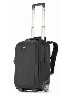 a black suitcase with wheels and handle on the front, sitting against a white background