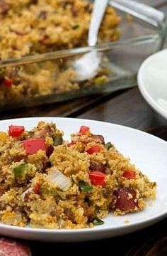 a white plate topped with food next to a casserole dish