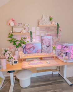 a desk with pink flowers and pictures on the wall above it, along with other items