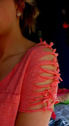 a woman in an orange top with cut out shoulders