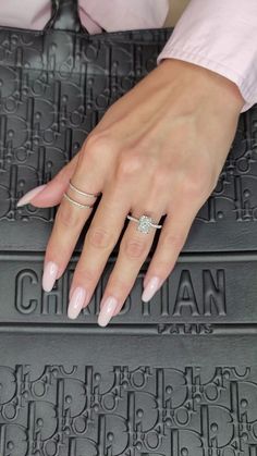 a woman's hand on top of a mat with a diamond ring in it