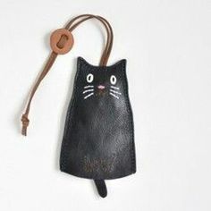 a black cat purse hanging on a cord