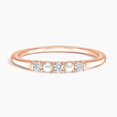 a rose gold ring with three diamonds