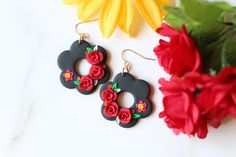 two pairs of earrings with flowers on them