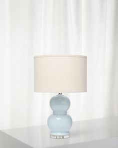 a blue lamp sitting on top of a white table