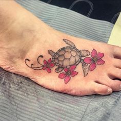 a foot with a turtle and flowers on it