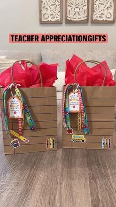 two brown paper bags with teacher appreciation gifts in them on top of a wooden table