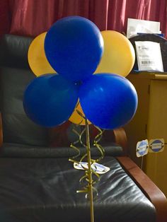 blue and yellow balloons are on a chair