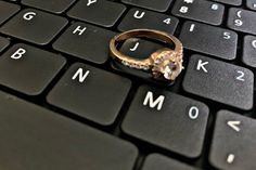 a gold ring sitting on top of a computer keyboard