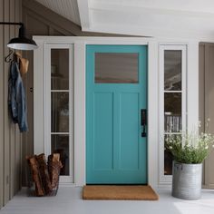 a blue front door on the side of a house with an advertise for it