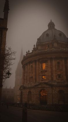 an old building with a dome on top in the fog