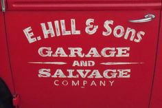 a red refrigerator with the words e hill & sons garage and salvage company on it