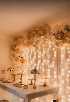 a table topped with lots of balloons and candles