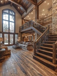 a large living room with wood floors and stone walls