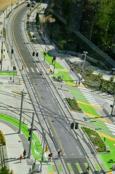 an aerial view of a city street with green markings