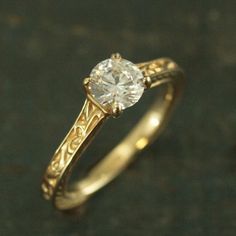 a close up of a ring with a diamond in it