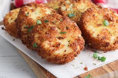 three crab cakes sitting on top of a cutting board