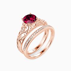 an engagement ring set with two bands and a pink tourmaline stone