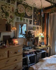 a bedroom with lots of clutter on the floor and walls, including a bed