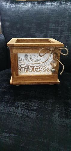 a wooden box sitting on top of a black couch