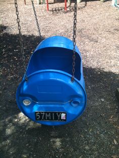 a blue plastic swing set in a park