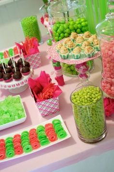 a table topped with lots of candy and candies on top of it's trays