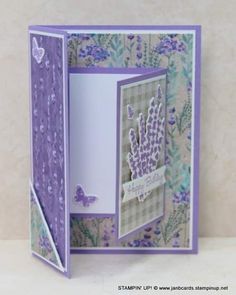 an open card with purple flowers and butterflies on the front, in a white background