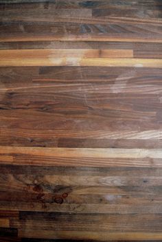 a wooden floor with some brown and white lines on the top half of it's surface