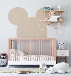 a baby's room with a mickey mouse wall decal