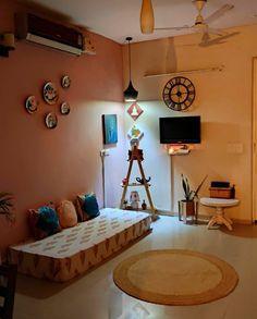 a living room filled with furniture and lots of clocks hanging on the wall above it