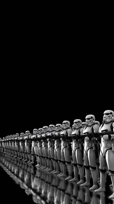 a group of toy figurines are lined up in the shape of stormtroopers