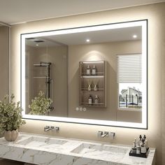 a bathroom with two sinks and a large mirror over the sink that has lights on it