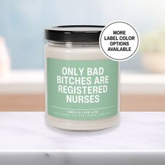 a jar of white candles with green labels on it