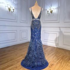 a dress on display in a room with white walls