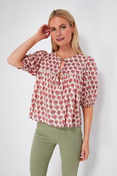 The India Collection by Emerson Fry works with a small group of artisans that specialize in heirloom hand print and dye techniques.Boho-chic blouse incoming! The Alma Puff Isla Top has a flowy silhouette with a split neckline and neck ties, as well as an all-over rosy floral block print. Casual enough for a day at the Bohemian Summer Tops For Gatherings, Spring Bohemian Tops For Gatherings, Bohemian Tops For Spring Gatherings, Bohemian Tie Neck Tops For Summer, Summer Bohemian Peasant Top With Tie Neck, Spring Bohemian Peasant Top With Split Neck, Jeans Sandals, Dye Techniques, Floral Block Print