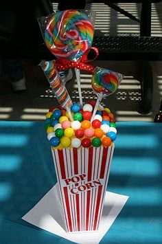 a box filled with candy and lollipops sitting on top of a table