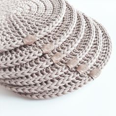 four woven baskets stacked on top of each other with metal pins sticking out of them