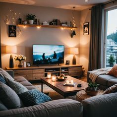 a living room filled with furniture and a flat screen tv sitting on top of a wooden table