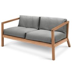 a wooden frame couch with grey cushions