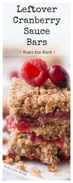 two dessert bars stacked on top of each other with raspberries and cranberry sauce