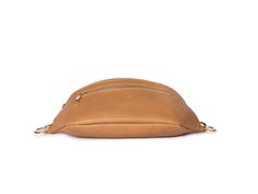 Step up your game with THE Bum Bag by Tottie. The tan with gold hardware bum bag is just the right size to keep your essentials organised and your hands free while on the go.Minimalist in tan with a luxe vibe, her clever design with the practicality every woman wants, but doesn't know exists, makes her irresistible. She’s crafted of vegan leather, with an adjustable strap that allows you to wear it cinched at the waist, across the body, or over the shoulder. Designed by women, for women who don't want to sacrifice style for practicality and efficiency.She’s thought of everything, a wide opening main zip compartment, gold hardware, and a front zip pocket to stash all the knick-knacks and whatnot! Our bum bag doesn't look like a typical bum bag, and she is as ideal for a day out, as she is f Travel Shoulder Belt Bag With Gold-tone Hardware, Travel Belt Bag With Gold-tone Hardware, Gold-tone Hardware Belt Bag For Travel, Everyday Crossbody Belt Bag With Gold-tone Hardware, Modern Belt Bag For Everyday Use With Gold-tone Hardware, Gold Belt Bag With Removable Pouch For Daily Use, Brown Belt Bag With Gold-tone Hardware, Chic Gold Belt Bag For Everyday, Belt Bag For Women