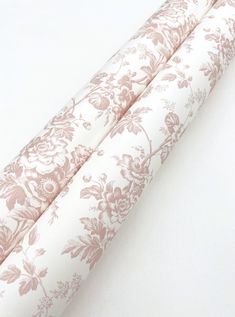 two rolls of white and pink floral fabric