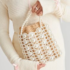 Crotchet And Pearl In One Bucket Bag, The Combo You Didn't Know You Needed. This Elegant And Unique Purse Provides An Outer Layer Covered In Small And Large Pearls, While The Raffia Insert Keeps All Your Belongings Safe And Secure.&Nbsp; Dimensions: 7.8" L X 2" W X 10" H Drop= 9" Raffia And Synthetic Pearl + Raffia Trim Handmade Crochet Raffia Pouch + Hand Strung Pearl Detailing Drawstring Closure Elegant Cream Crochet Bag For Spring, Elegant Handwoven Crochet Bag For Spring, Elegant Spring Crochet Woven Bag, Elegant White Crochet Bag For Shopping, Elegant White Crochet Bag For Summer, White Handwoven Shoulder Bag, Elegant Spring Crochet Bag, Elegant White Handwoven Crochet Bag, Elegant White Handwoven Bag