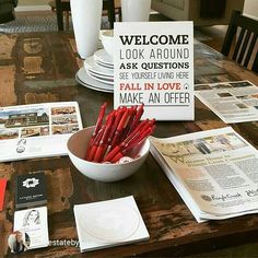 there is a bowl full of red crayons on the table next to newspapers