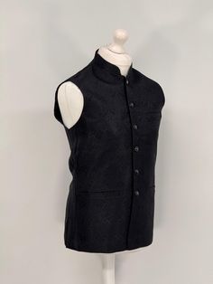 Introducing our exquisite Men's Jamawar Waistcoat, a luxurious addition to any gentleman's wardrobe. Handcrafted from the finest quality Jamawar fabric, this waistcoat is fully lined for added comfort. Featuring a timeless design, it comes with complimenting buttons that add a touch of elegance to any outfit. The waistcoat also comes with pockets, providing ample storage space for your essentials. Perfect for formal occasions, this waistcoat is sure to make a statement and impress all those arou Festive Formal Fitted Vest, Elegant Nehru Jacket For Business, Sleeveless Nehru Jacket For Formal Festive Occasions, Festive Sleeveless Nehru Jacket For Formal Occasions, Classic Nehru Jacket For Formal Occasions, Classic Nehru Jacket For Business, Fitted Sleeveless Nehru Jacket For Winter, Elegant Sleeveless Festive Outerwear, Classic Nehru Jacket With Stand Collar For Business