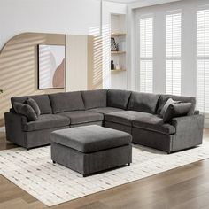 a living room with a sectional couch and ottoman