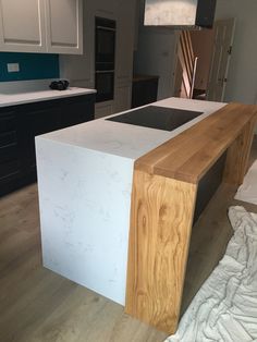 a kitchen with an island made out of wood and white marble